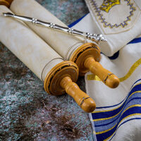 Prayer shawl (tallit) with Torah scroll in a synagogue