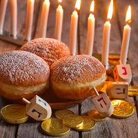 Menorah, doughnuts, chocolate coins and wooden dreidels