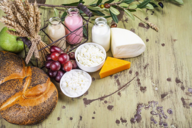 Milk, bread, fruits and dairy products on wooden table